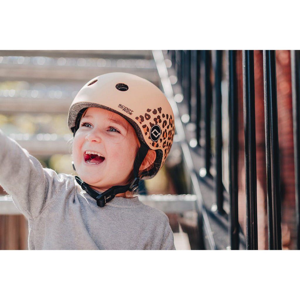 smiling girl wearing Scoot and Ride Helmet - XXS - S - Leopard
