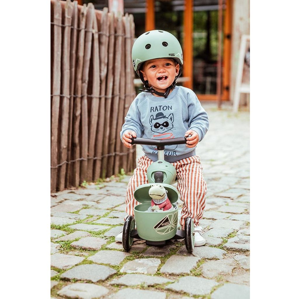 boy sitting onScoot and Ride Highwaykick 1 Lifestyle Scooter - Green Lines on cobbled street