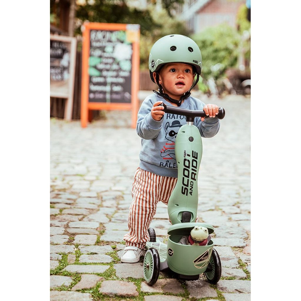 boy standing on Scoot and Ride Highwaykick 1 Lifestyle Scooter - Green Lines on cobbled street