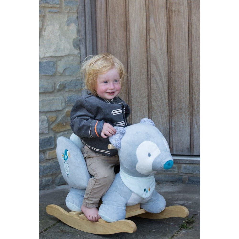 child riding Nattou Baby Rocker - Tiloo the Wolf on patio