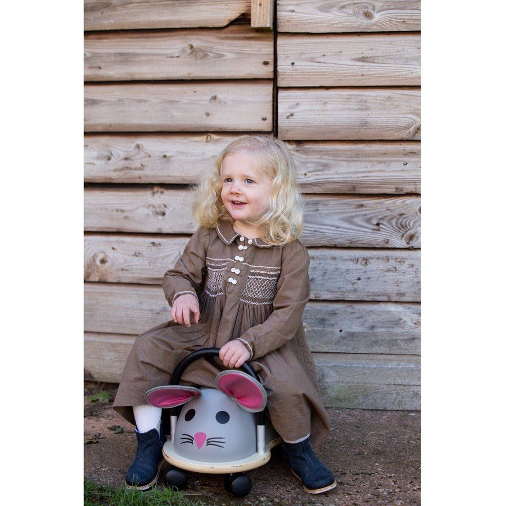 little girl sitting on Wheelybug Ride On - Mouse