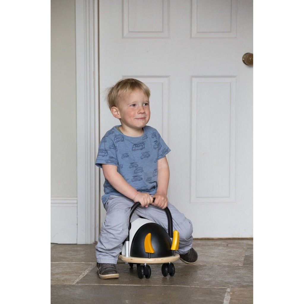 little boy riding Wheelybug Ride On - Cow