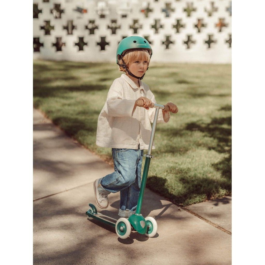 Little boy riding Banwood Scooter Age 3+ in Green on pavement