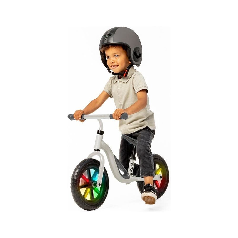 boy riding Chillafish Charlie Glow Balance Bike 18M-4Y in Beige