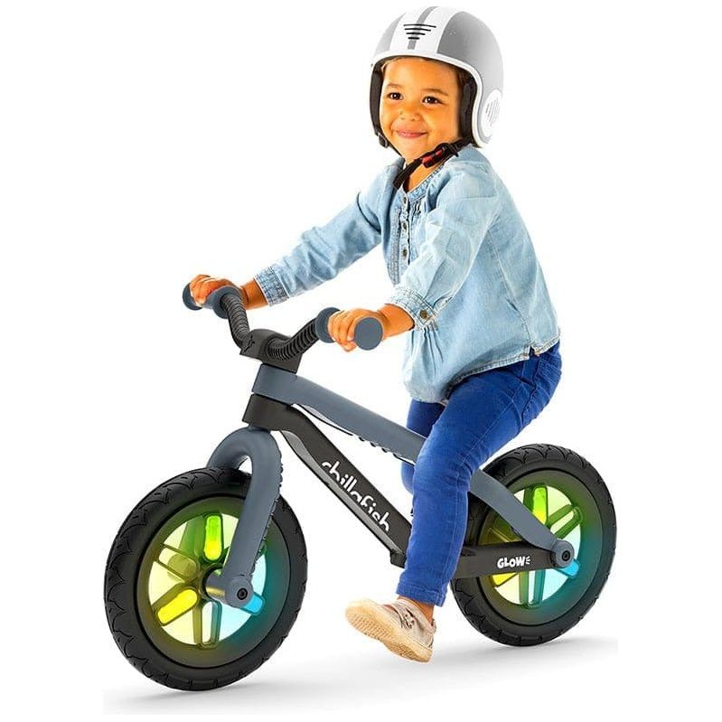 Little boy sitting on Chillafish Bmxie Glow Balance Bike 2-5 Years Anthracite Grey