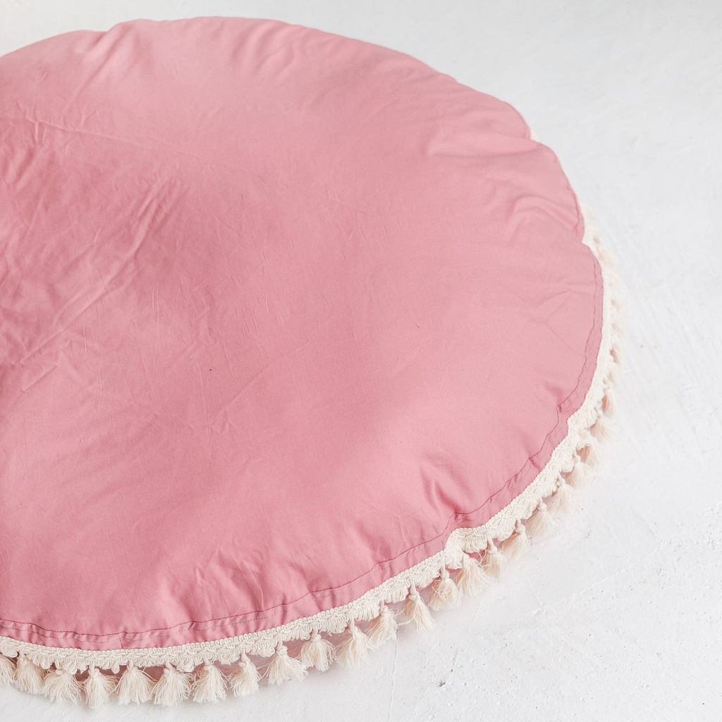 close up of MINICAMP Large Floor Cushion With Tassels in Rose