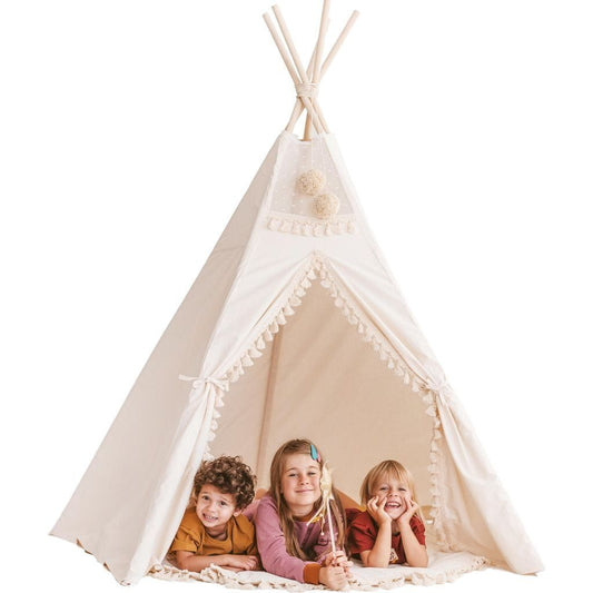 three children lying in MINICAMP Extra Large Indoor Teepee Tent With Tassels Decor in Boho Style