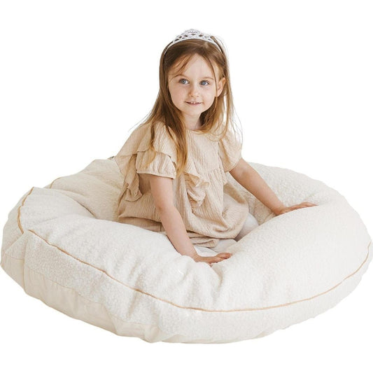 girl sitting in MINICAMP Boucle Fabric Kids Floor Cushion in Ecru