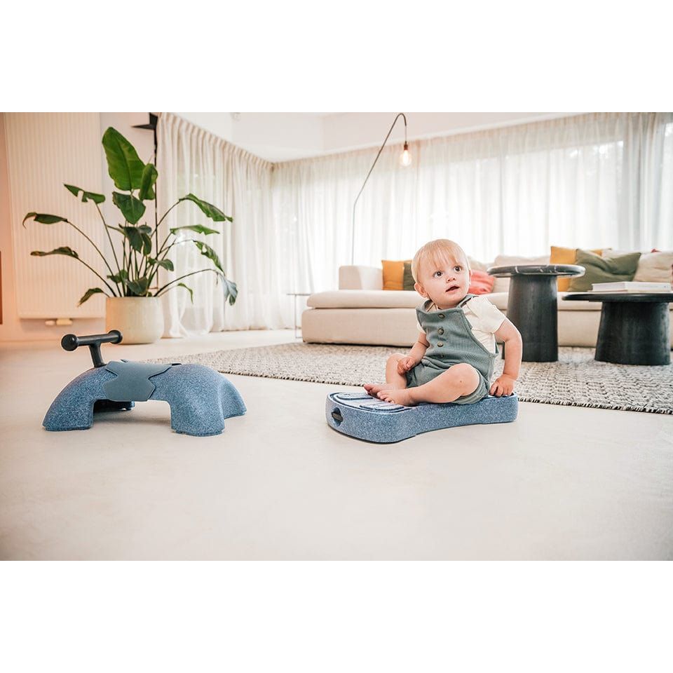 boy sitting on bottom plate of Scoot and Ride My First 3-in-1 Baby Walker & Ride on - Steel