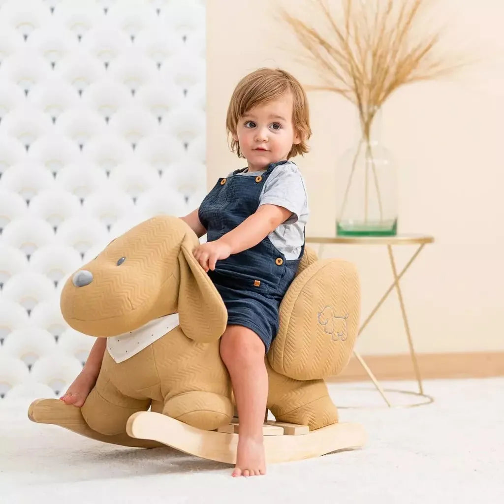 boy riding Nattou Baby Rocker - Charlie the Dog Caramel