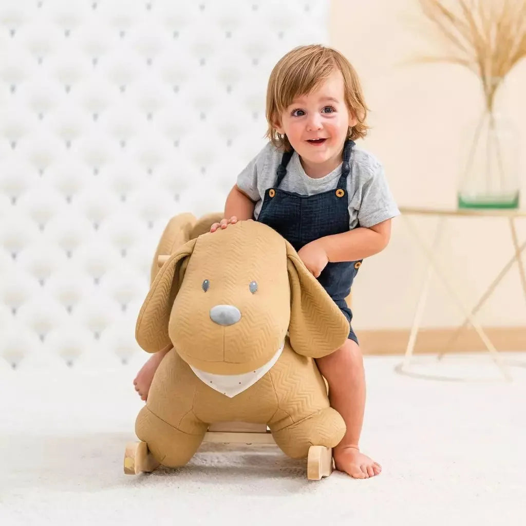 smiling boy sitting on Nattou Baby Rocker - Charlie the Dog Caramel front
