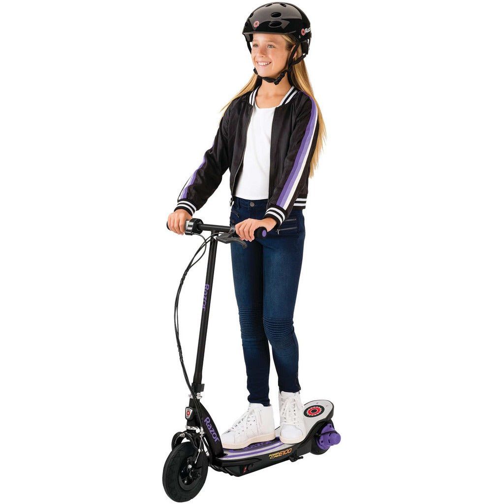 girl in helmet iridng Razor Power Core E100 24 Volt Scooter - Purple