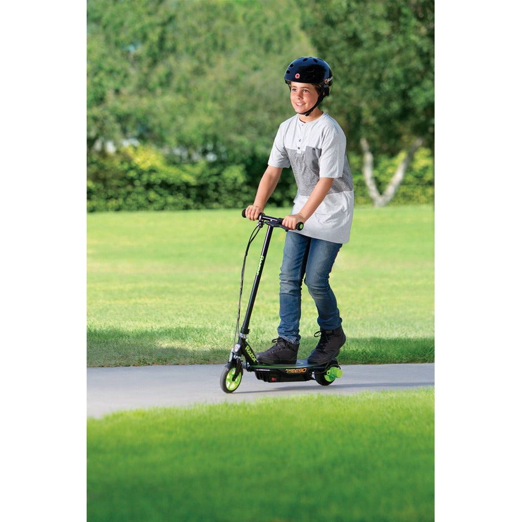 boy riding Razor Power Core E90 12 Volt Scooter - Green in park