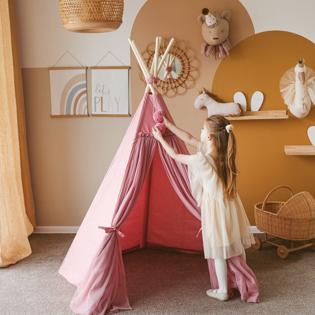 girl playing with pom poms in MINICAMP Fairy Kids Play Tent With Tulle in Rose