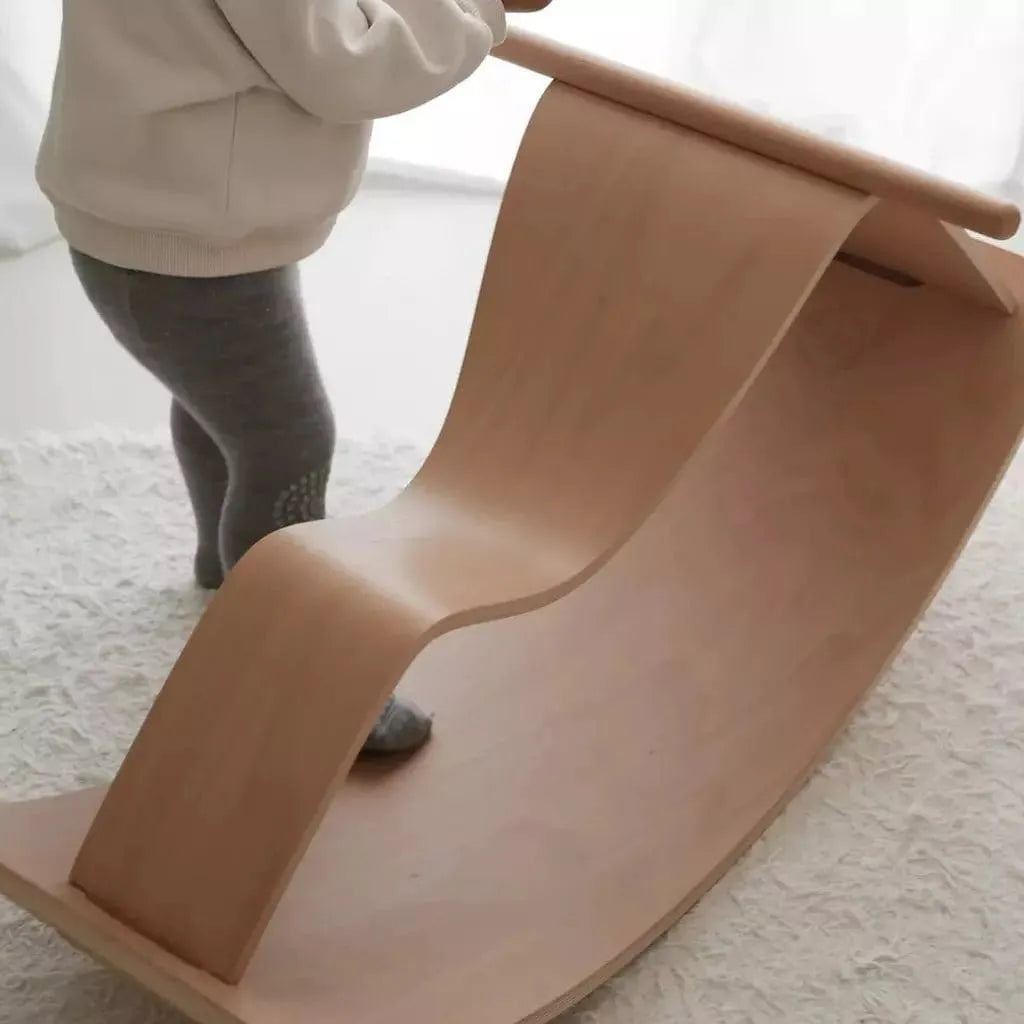 child standing with Curve Lab Rocking Horse & Perfect Arc Balance Board