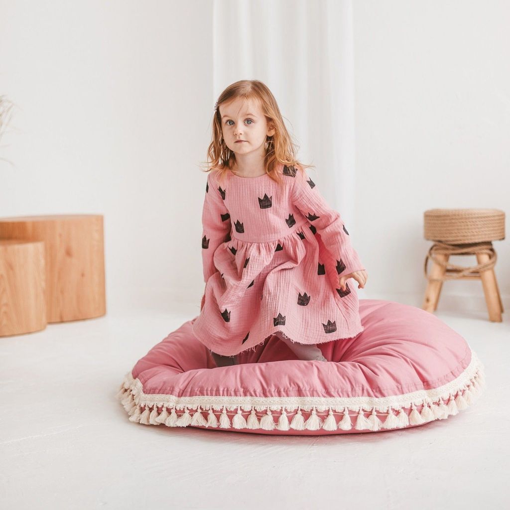 girl kneeling on MINICAMP Large Floor Cushion With Tassels in Rose