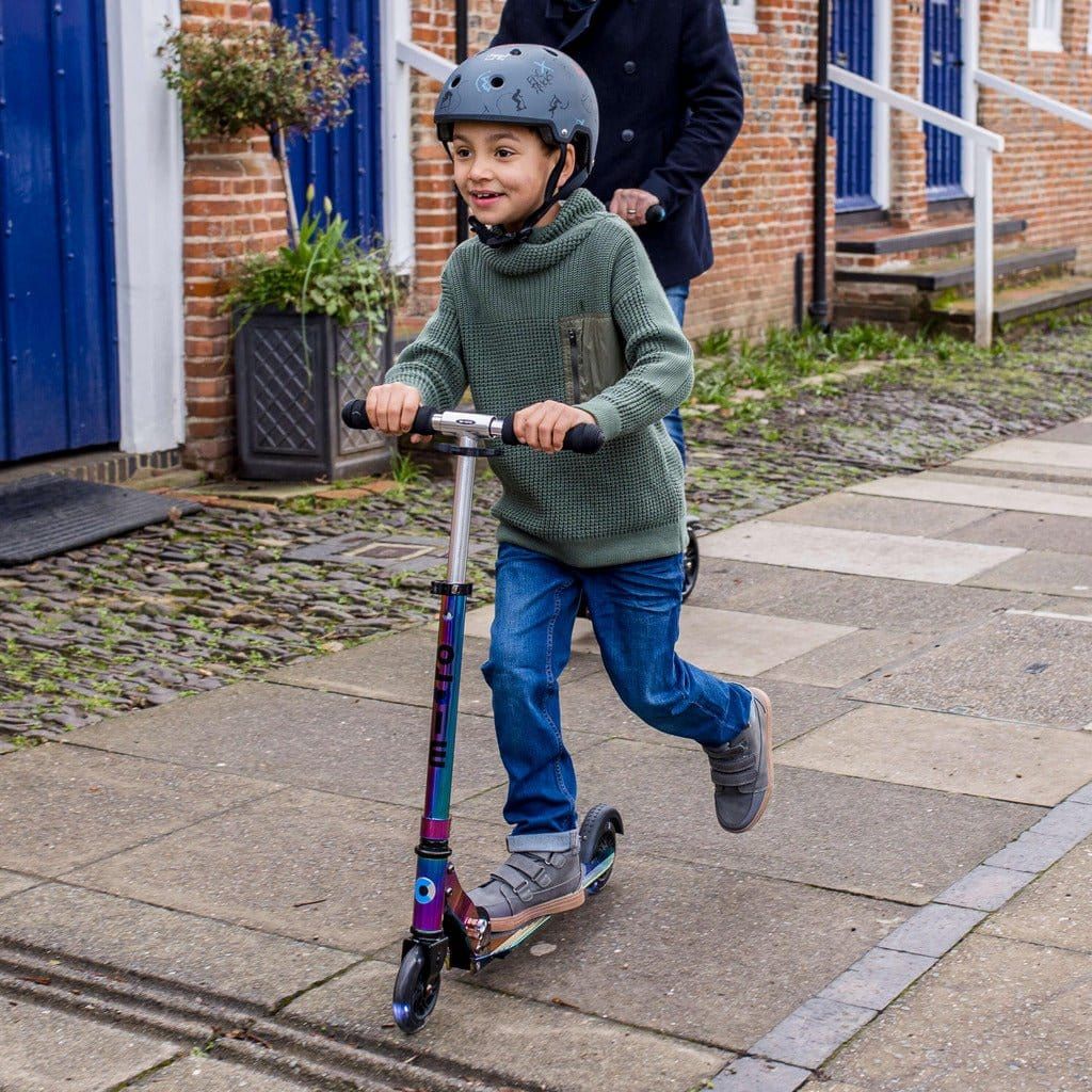 boy riding Micro Scooter Sprite LED - Neochrome