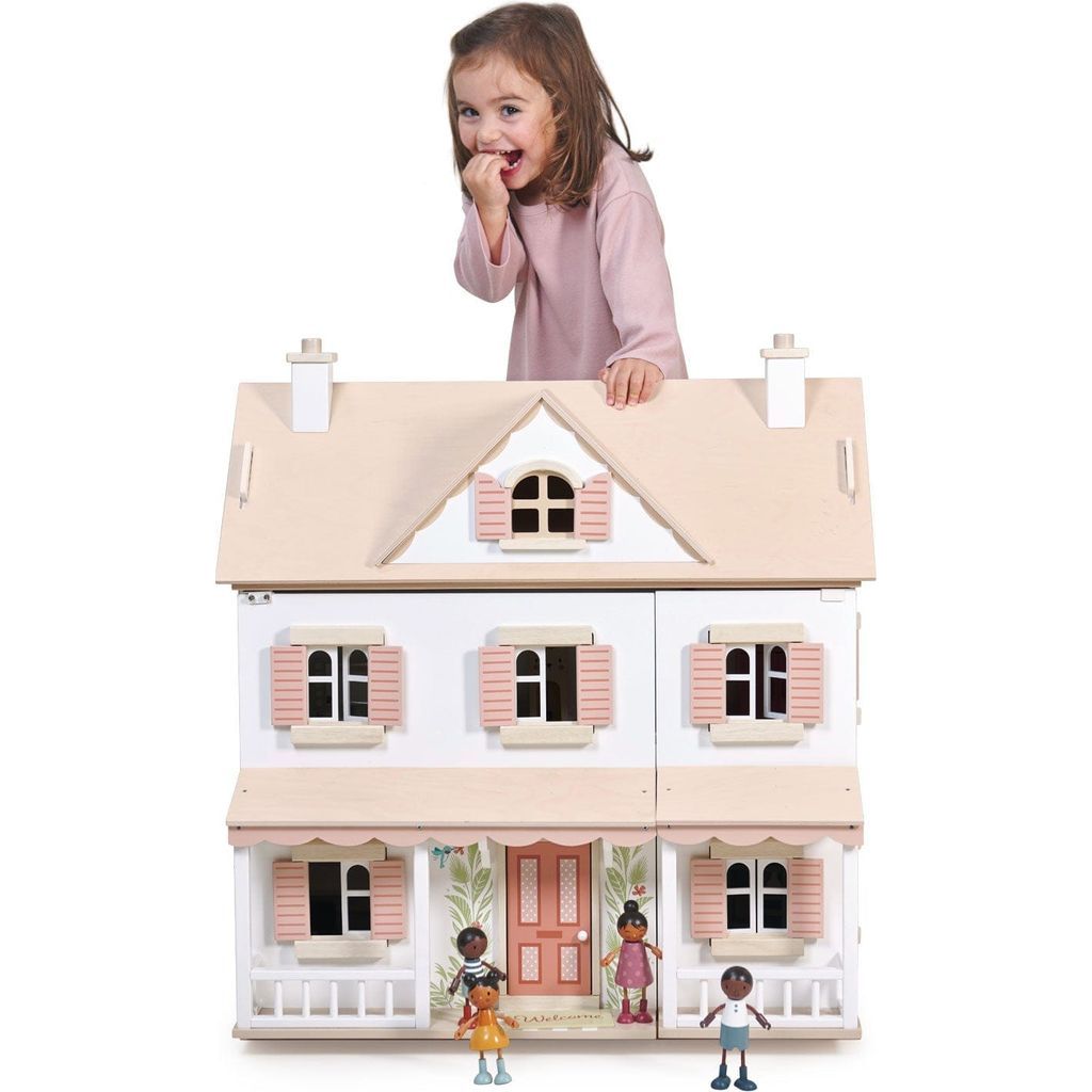 girl standing behind Tender Leaf Hummingbird Wooden Doll House