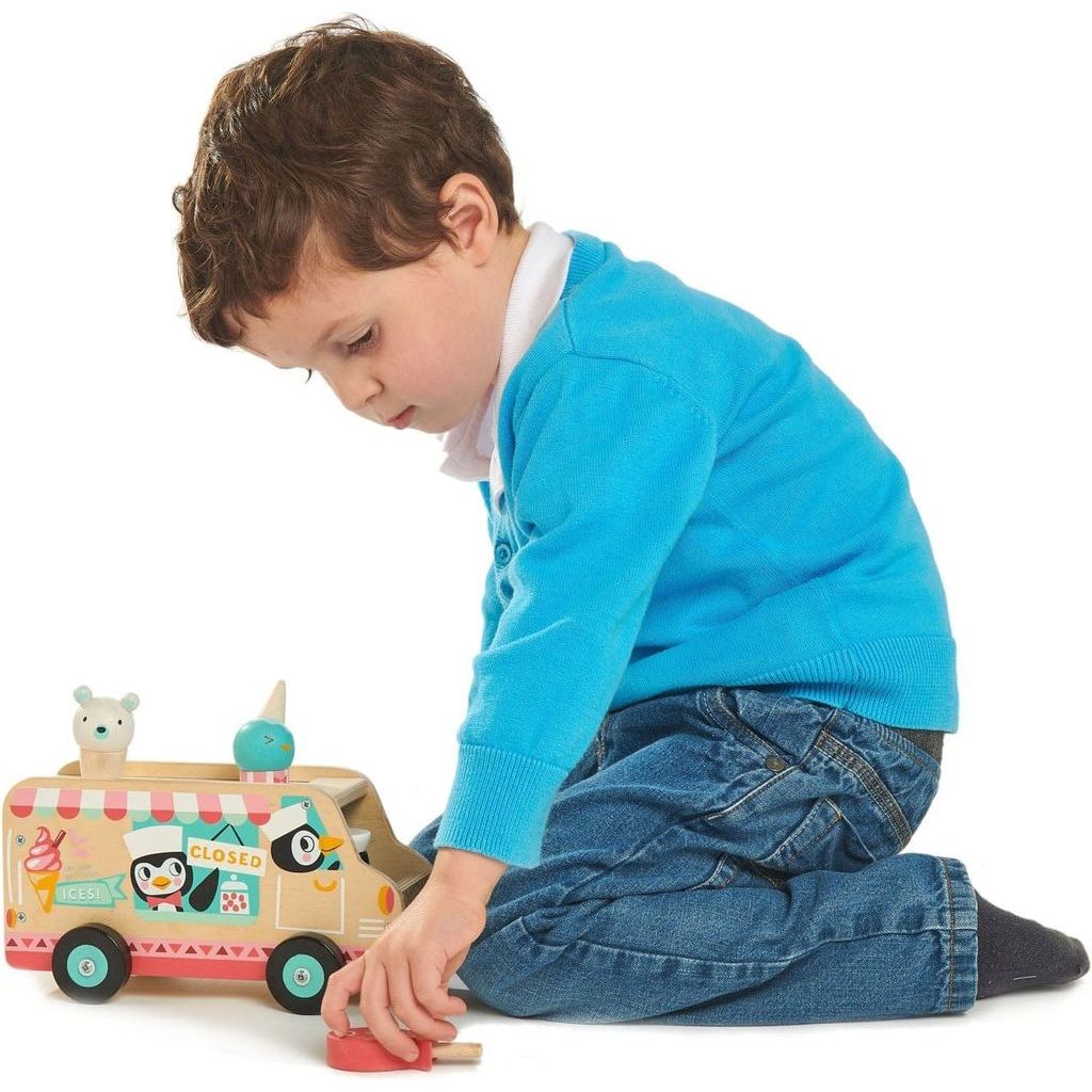 boy playing with Tender Leaf Penguin's Wooden Gelato Van