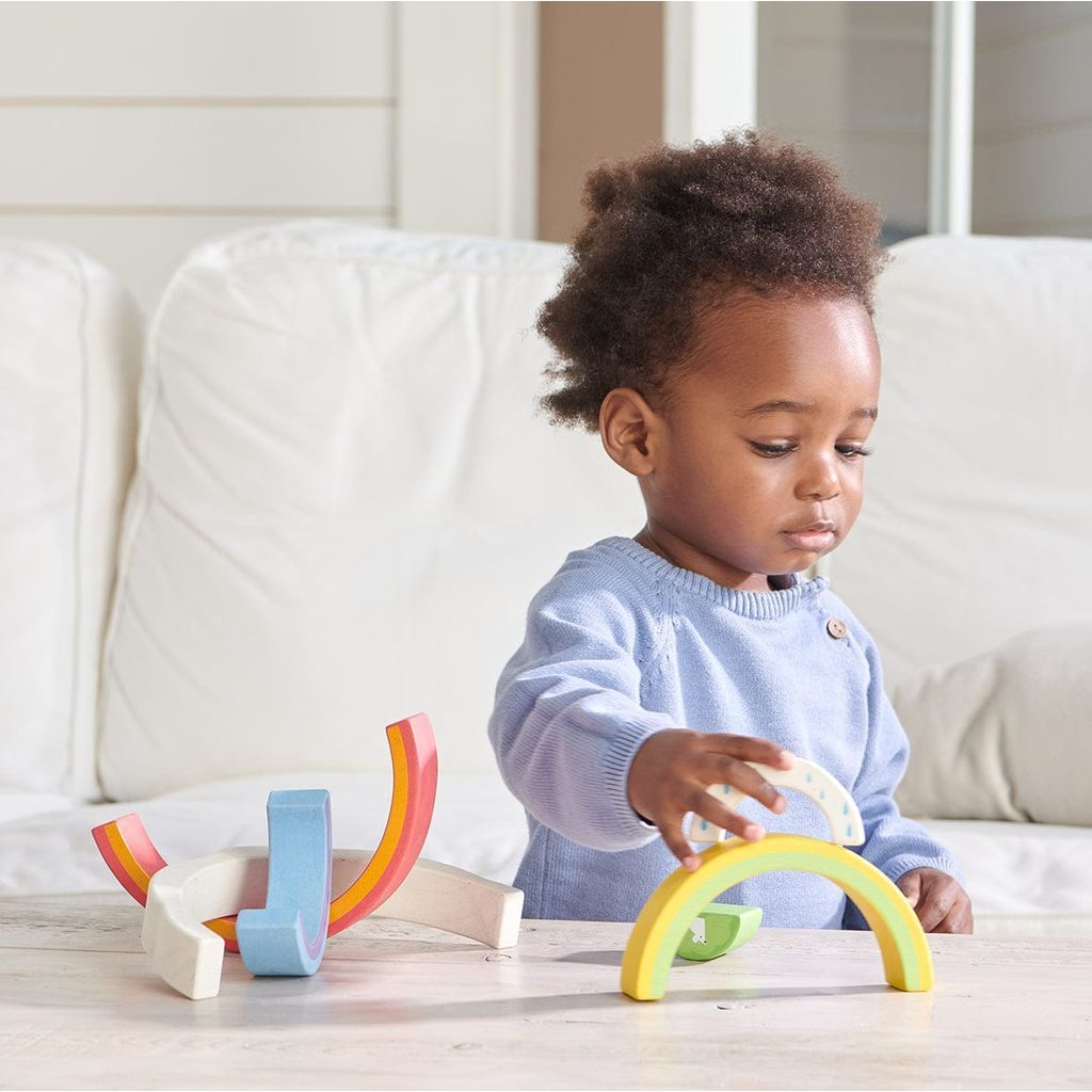 girl playing with Tender Leaf Peacock Colours & Rainbow Stacker Bundle