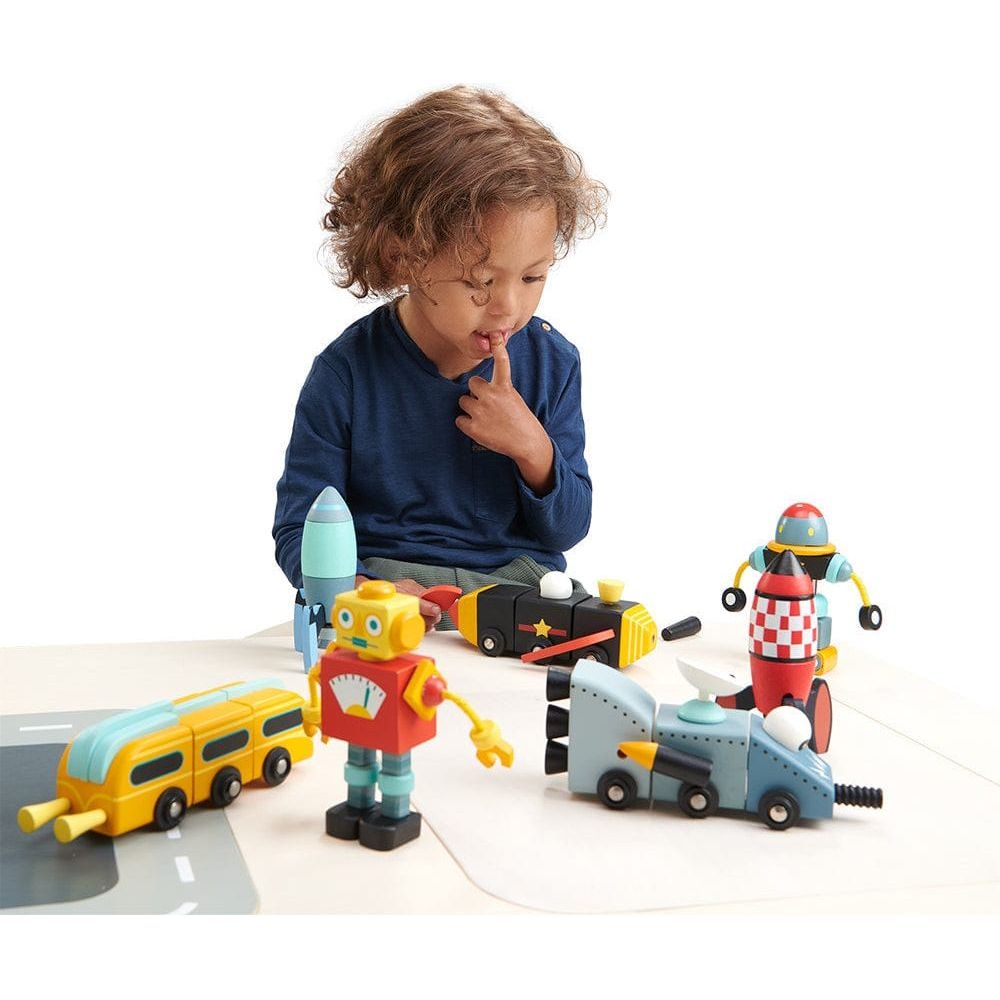 boy with finger in mouth playing with Tender Leaf Space Race Wooden Toys