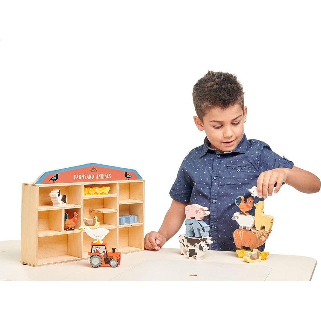 boy playing with Tender Leaf 13 Wooden Farmyard Animals Toys & Shelf