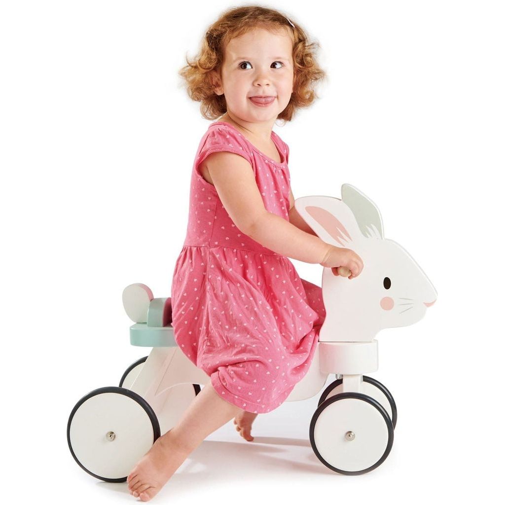 girl sitting on Tender Leaf Running Rabbit Wooden Ride On