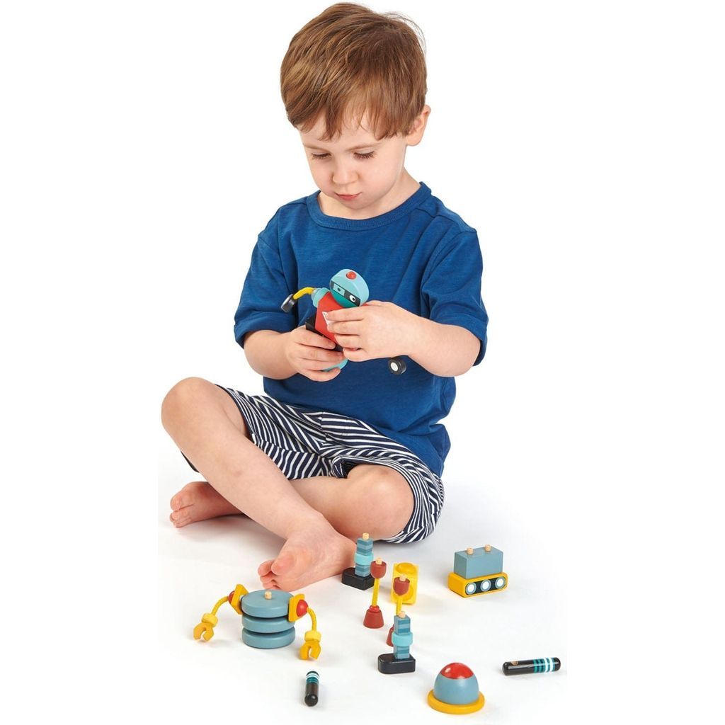 boy playing with Tender Leaf Robot Construction Wooden Figures
