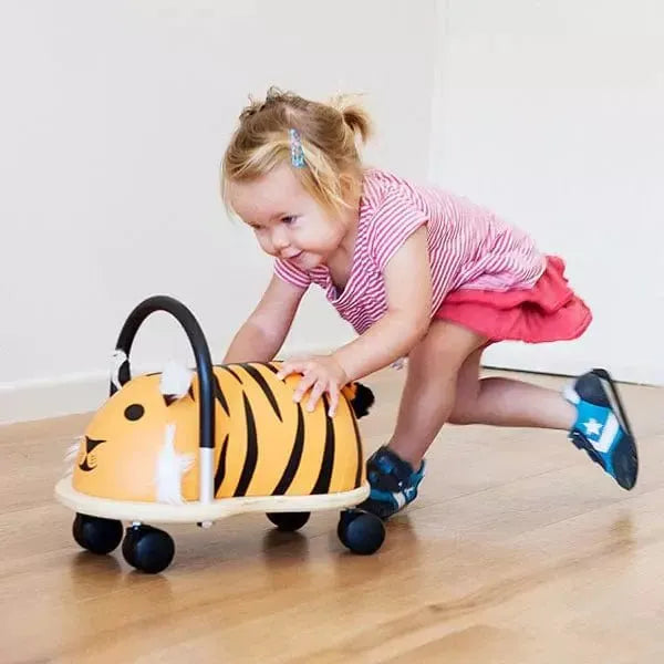 little girl pushing Wheelybug Ride On - Tiger