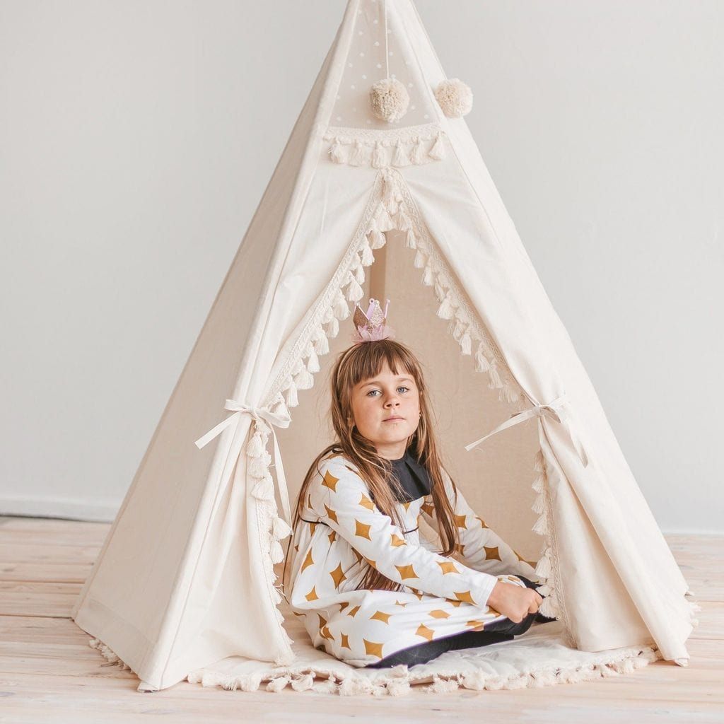 child sitting in MINICAMP Kids Playmat With Tassel Border