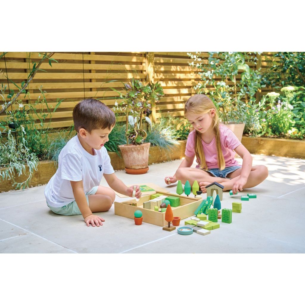 boy and girl on patio playing with Tender Leaf Little Garden Designer Wooden Toy