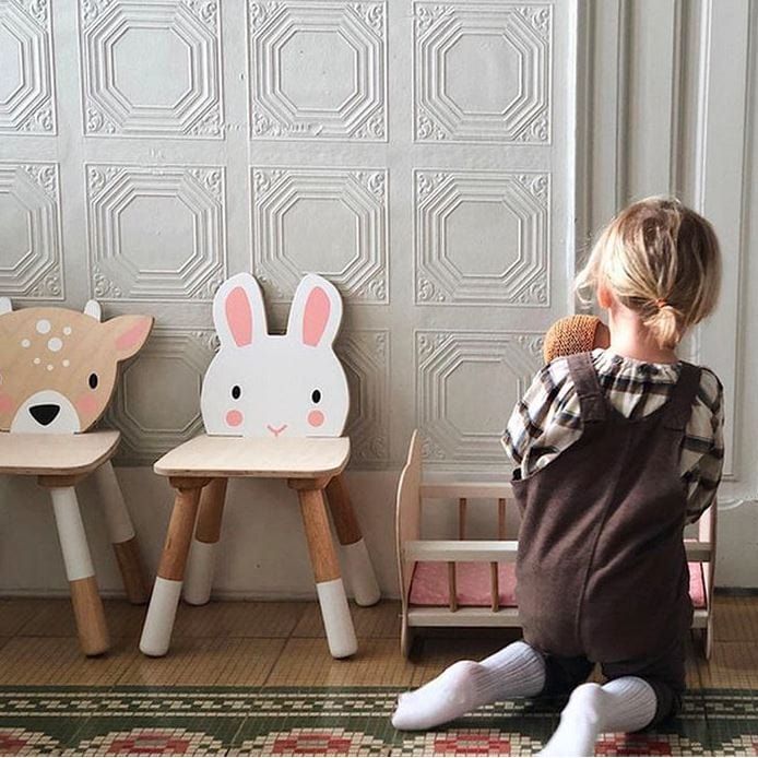 girl kneeling in front of Tender Leaf Forest Rabbit Wooden Kids Chair