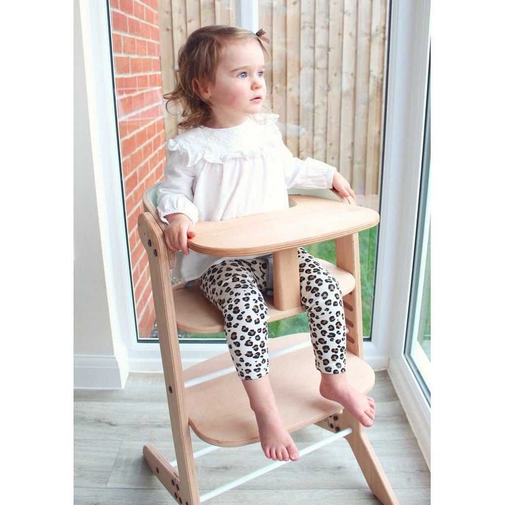 girl sitting in MamaToyz Mama High Chair by window