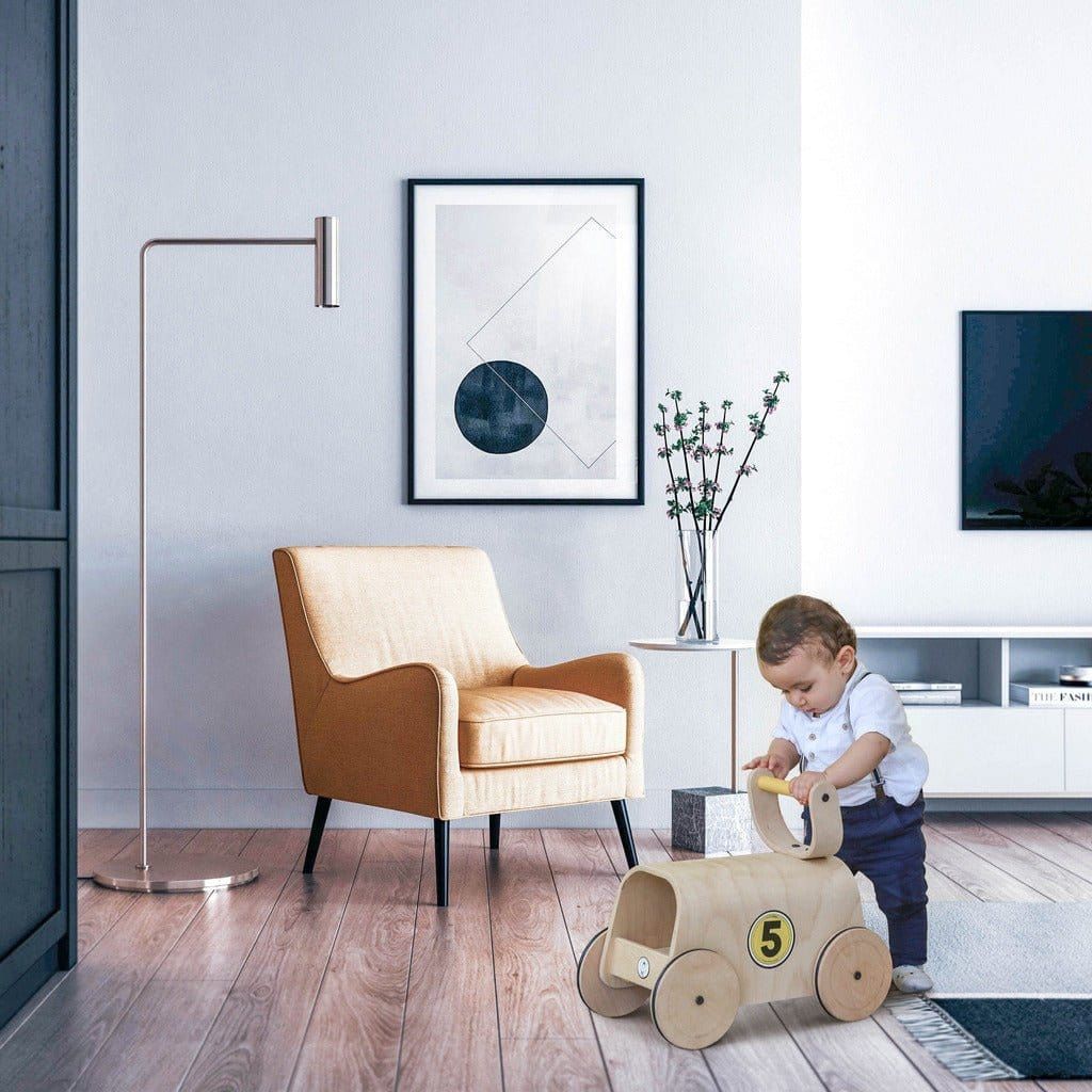 little boy in lounge standing with Mama Toyz Racer Ride-On - 10+ months