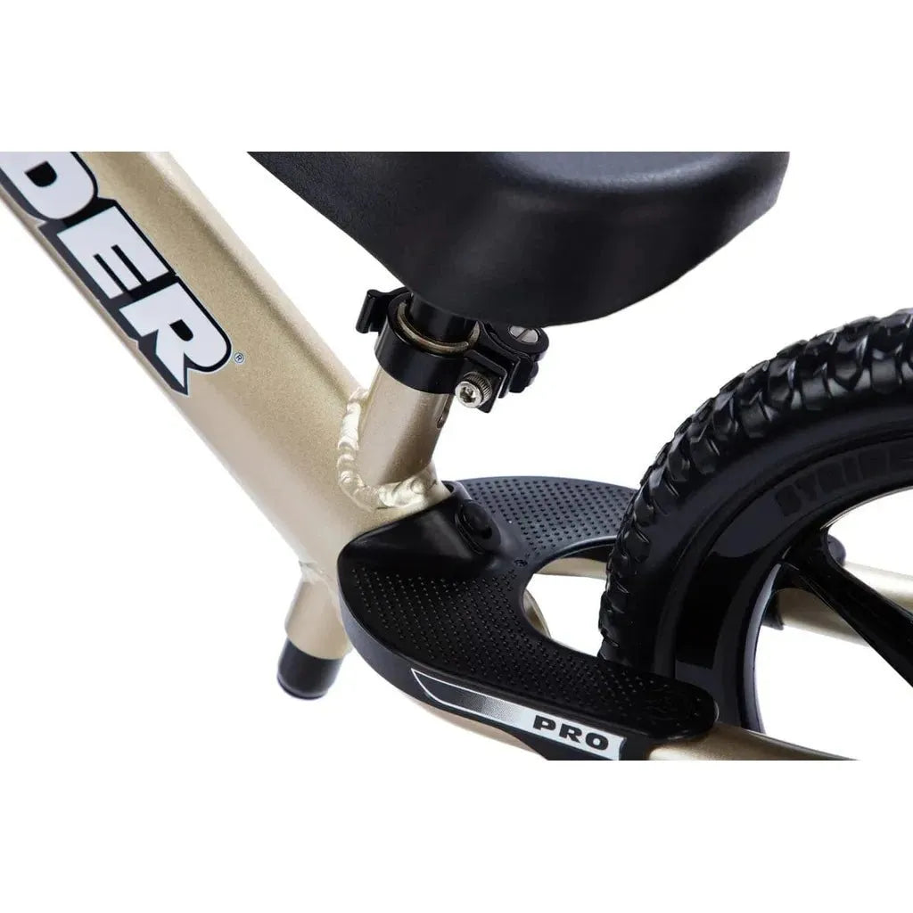 Strider Pro 12 inch Balance Bike - Gold foot rest close up