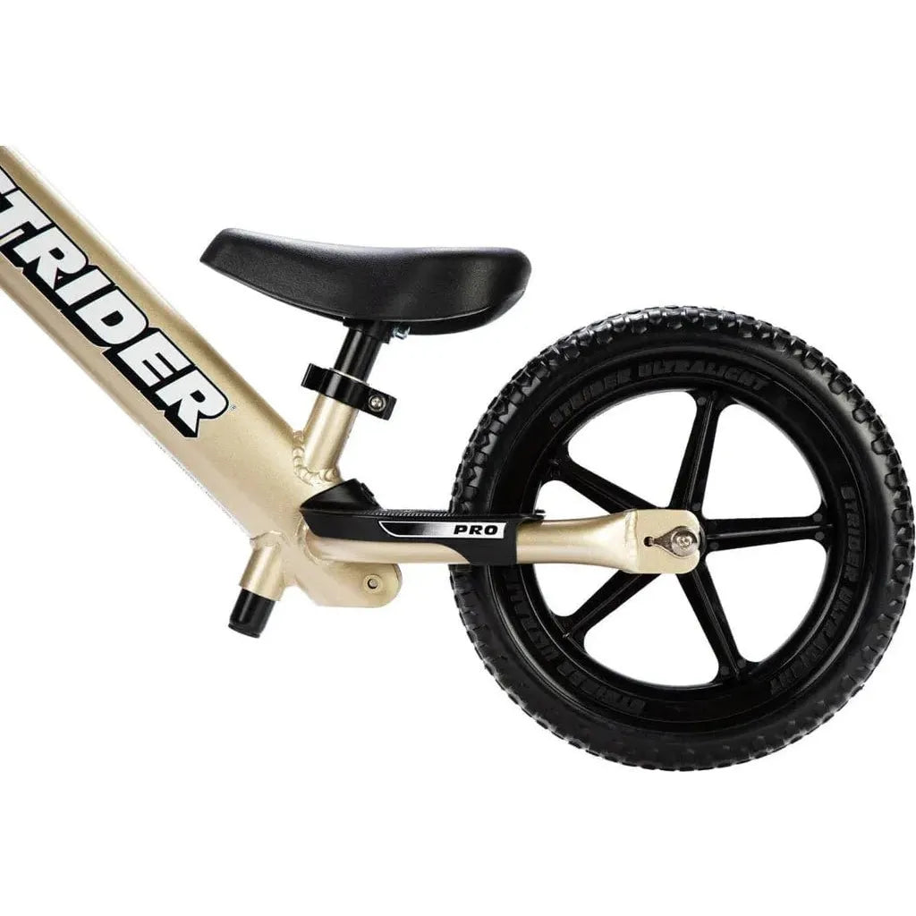 Strider Pro 12 inch Balance Bike - Gold rear wheel close up