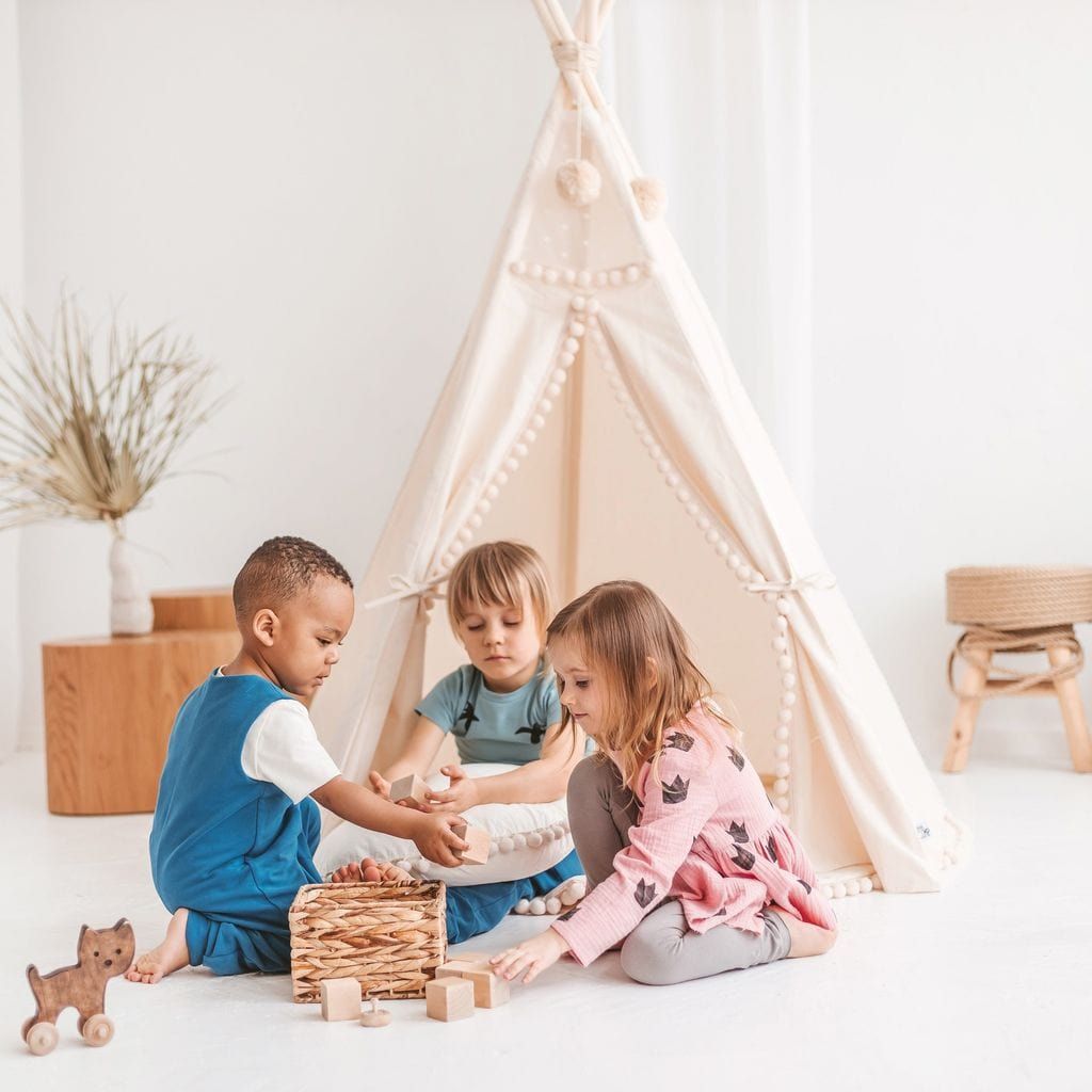 children playing with block in front of MINICAMP Original Play Tent With Pompoms