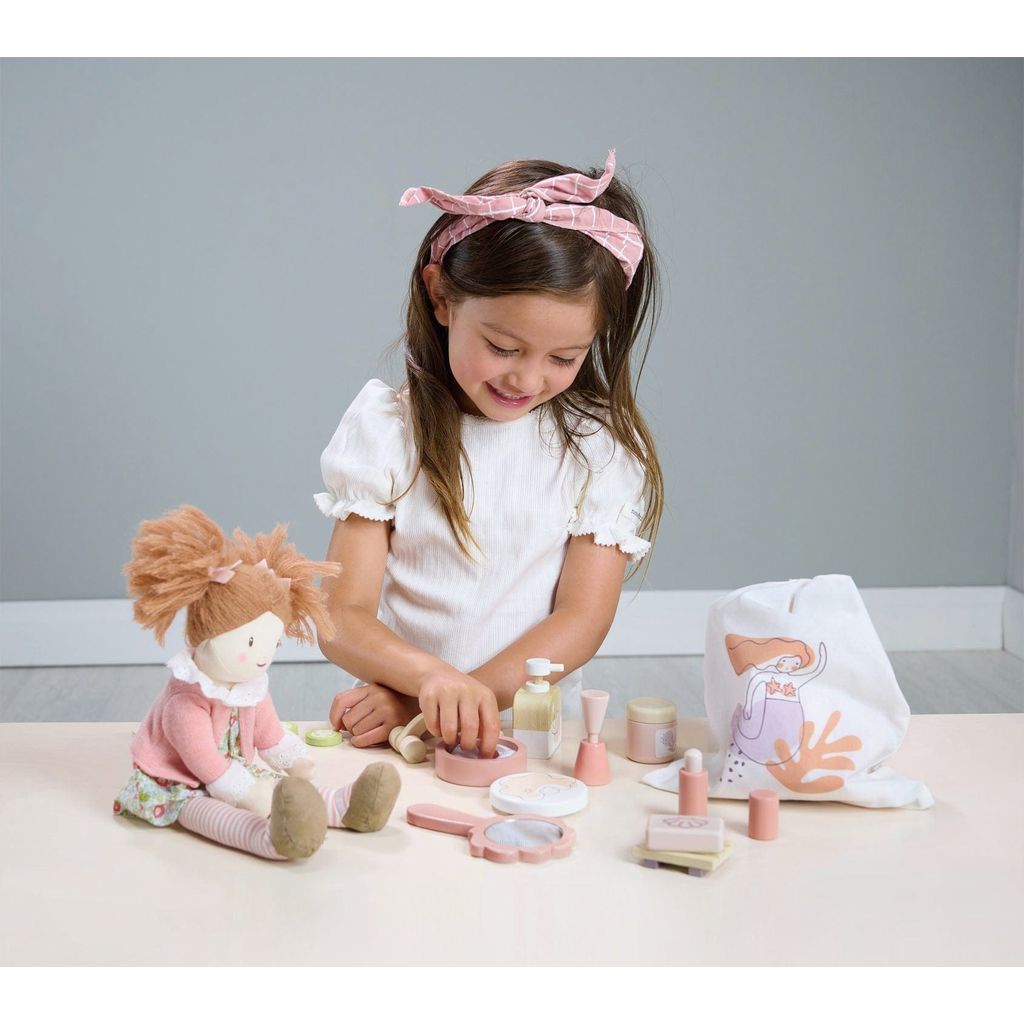 smiling girl playing wth Tender Leaf Wooden Toy Spa Retreat Set