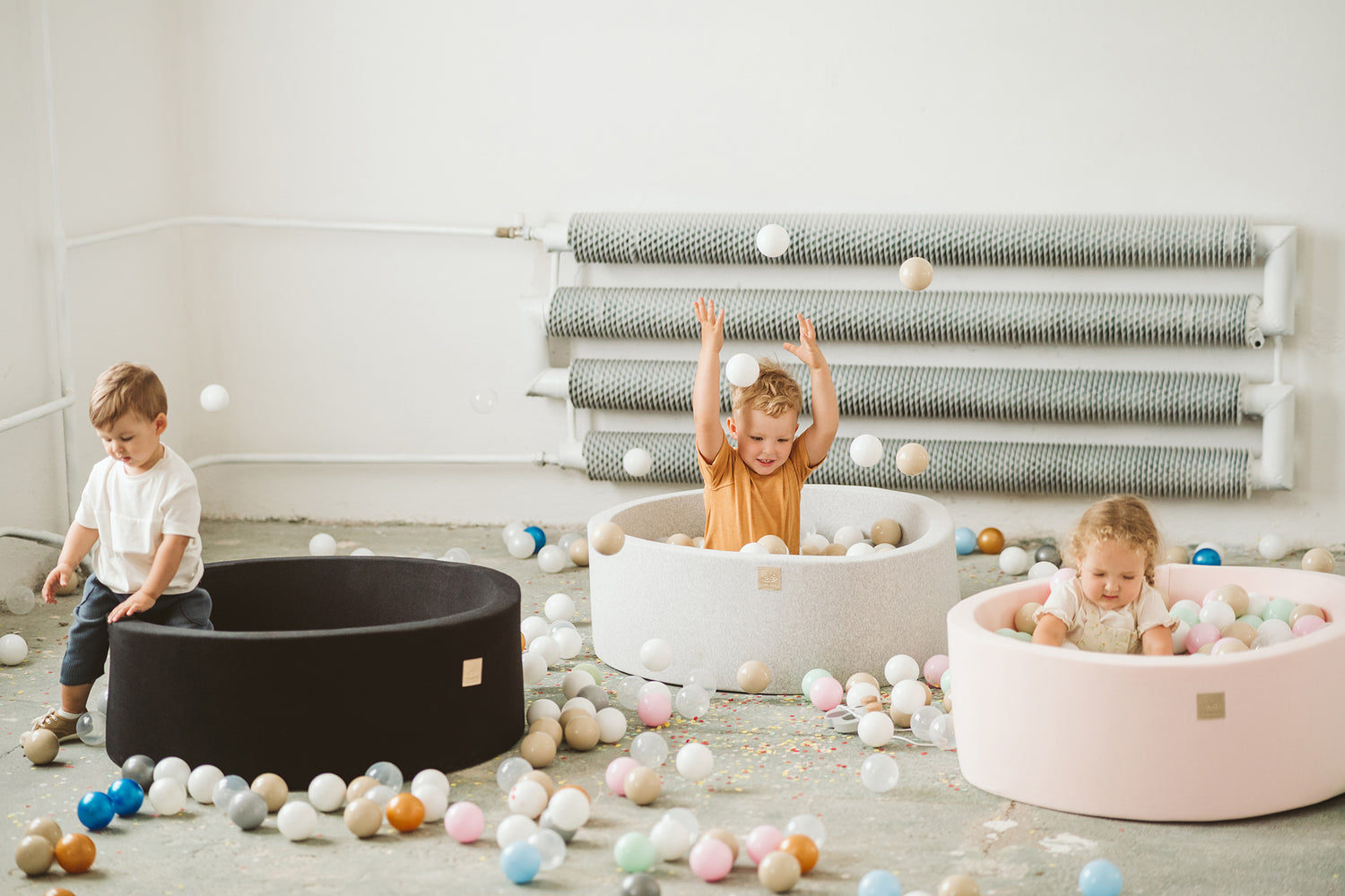 3 children in meowbaby luxury kids ball pits in black, white and pink