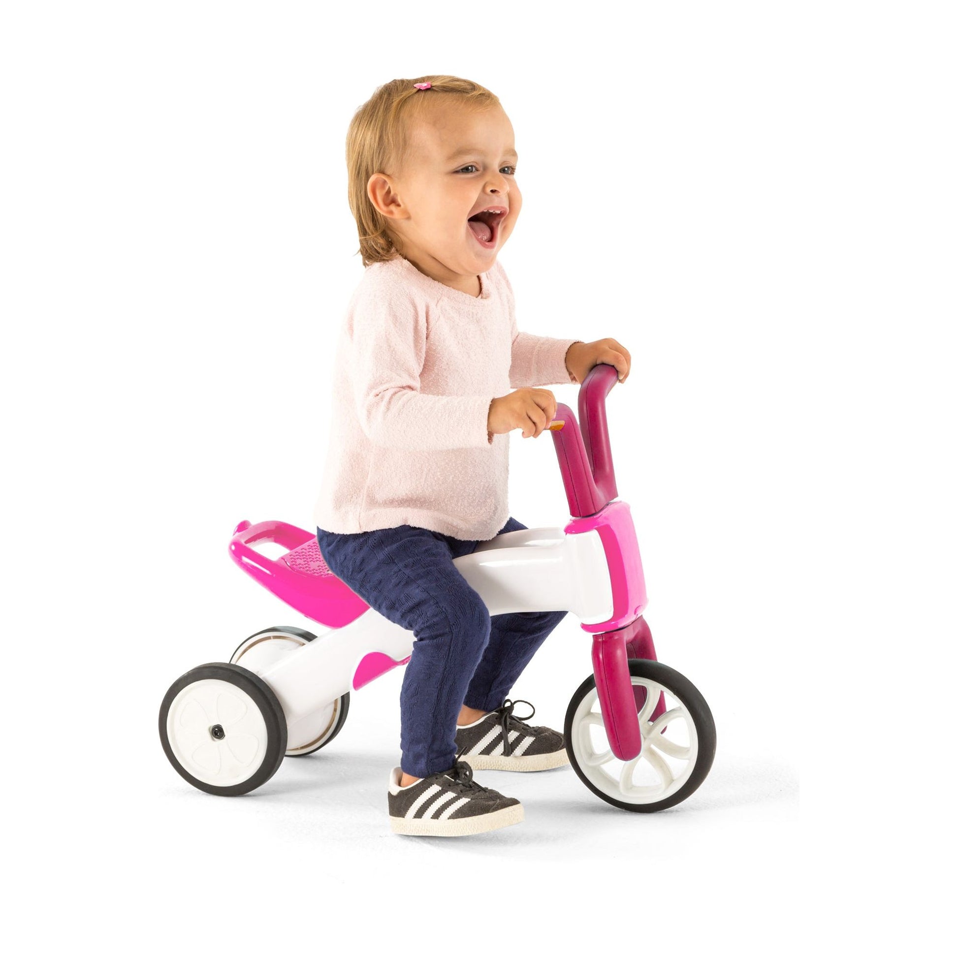smiling girl riding Chillafish BUNZI Trike Pink 