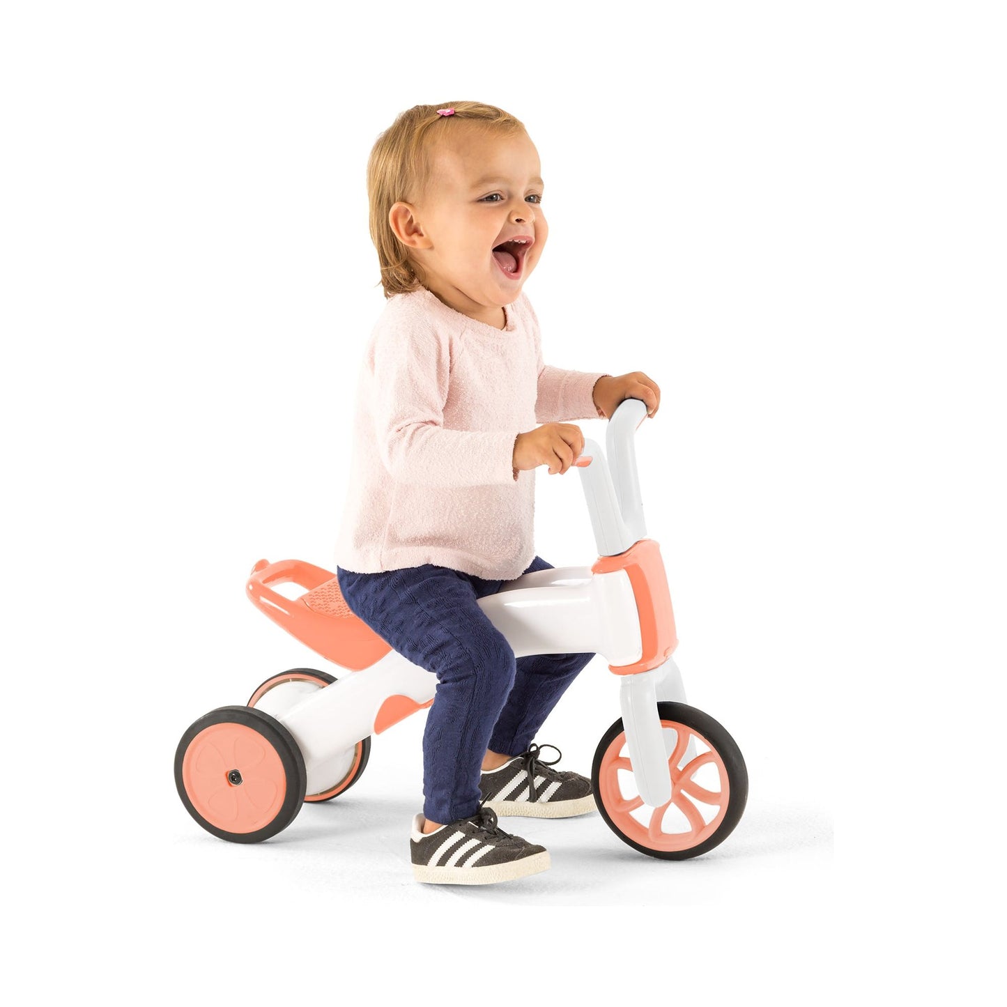 smiling girl riding Chillafish BUNZI Trike Flamingo 