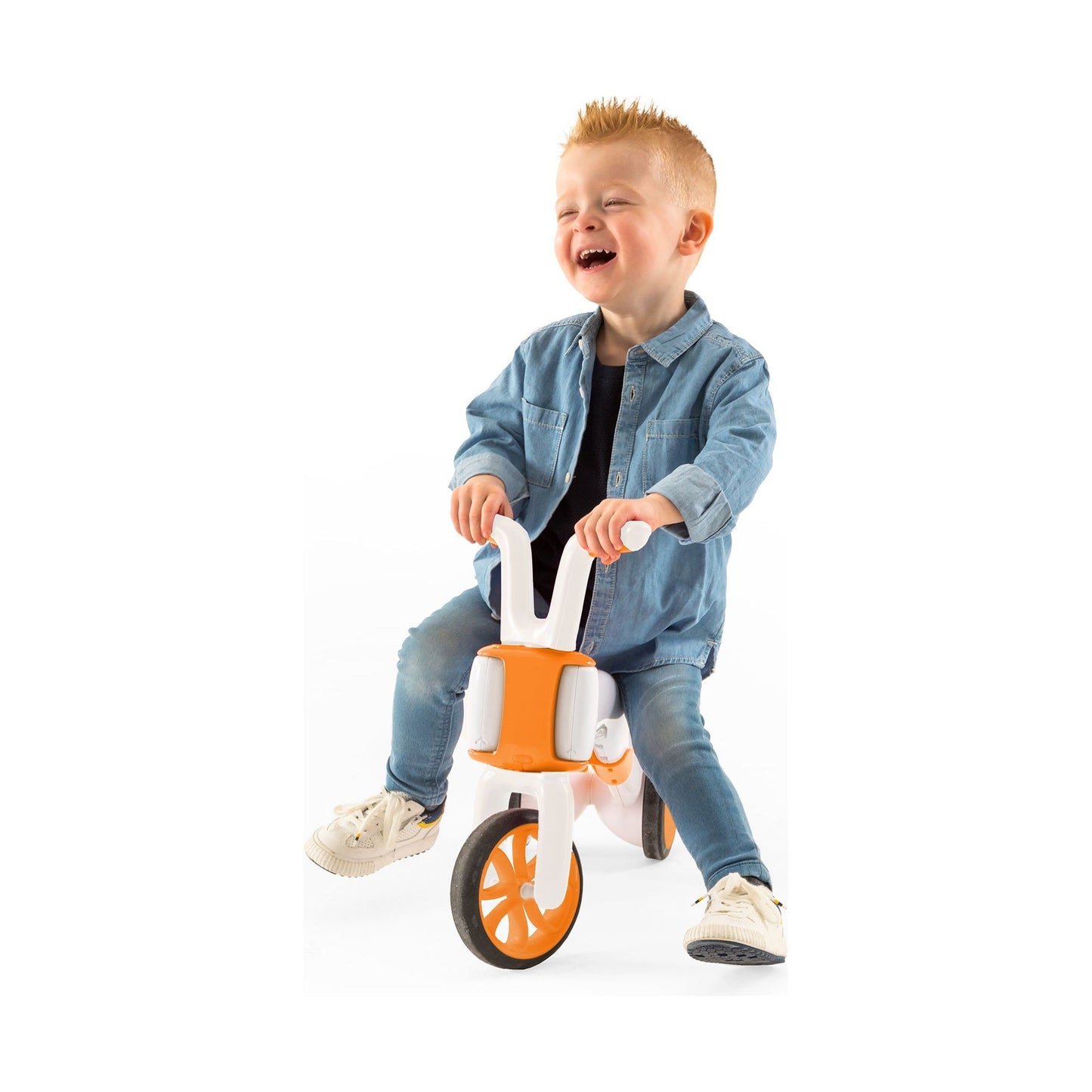 smiling boy riding Chillafish BUNZI Trike Ginger