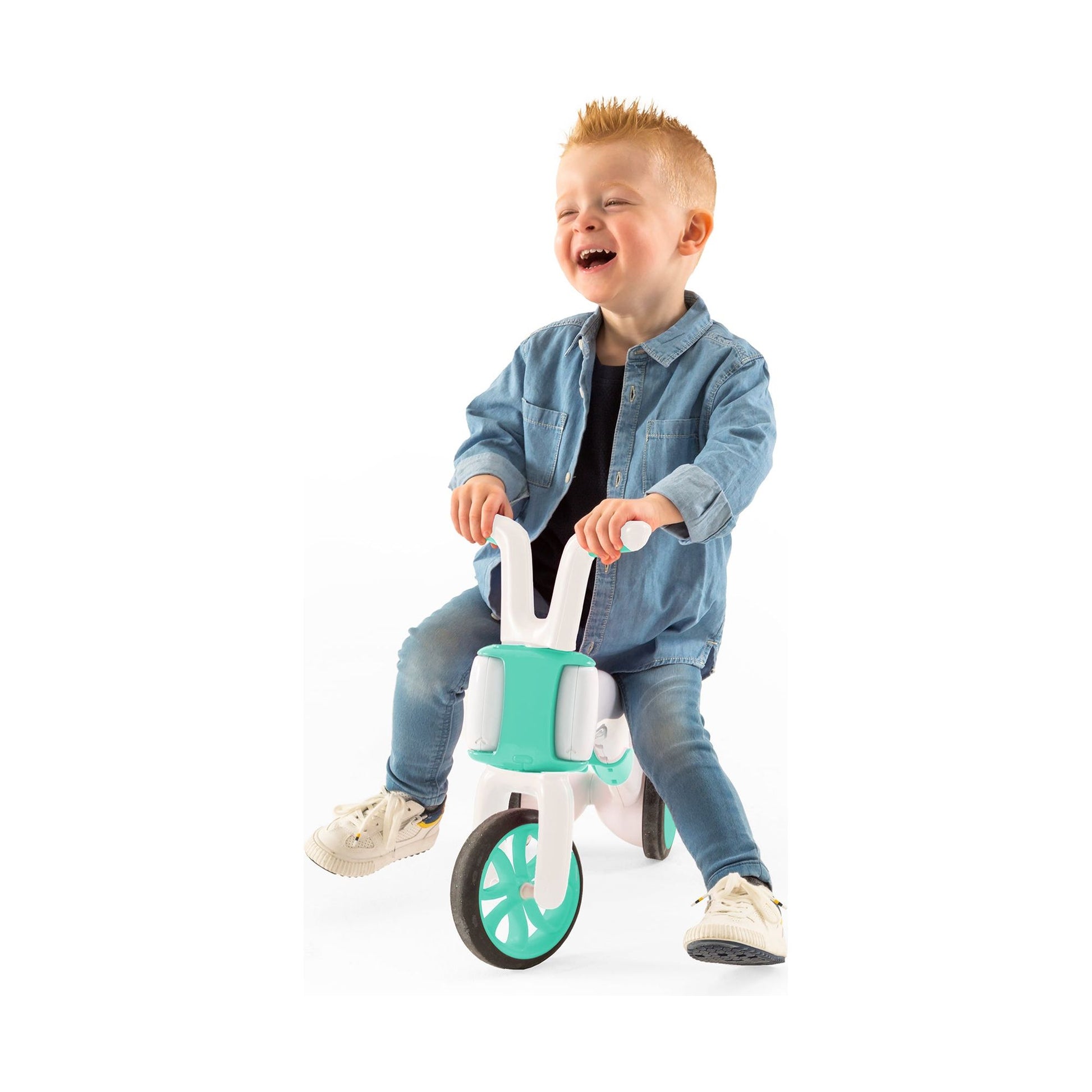 smiling boy riding Chillafish BUNZI Trike Mint 