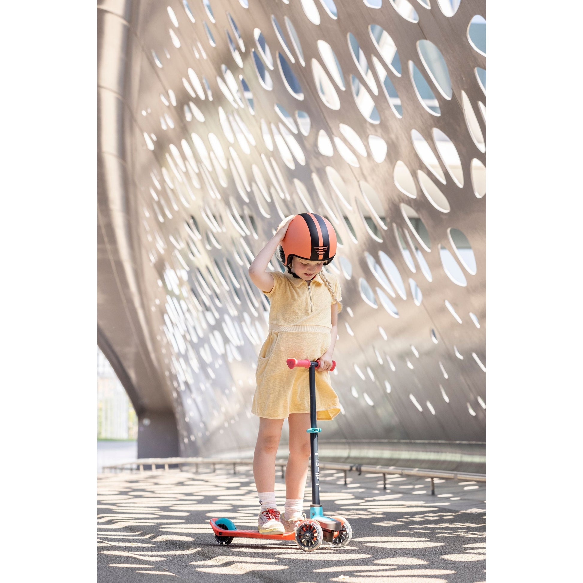 girl standing on scooter wearing Chillafish kids Helmet Bobbi XS Rose