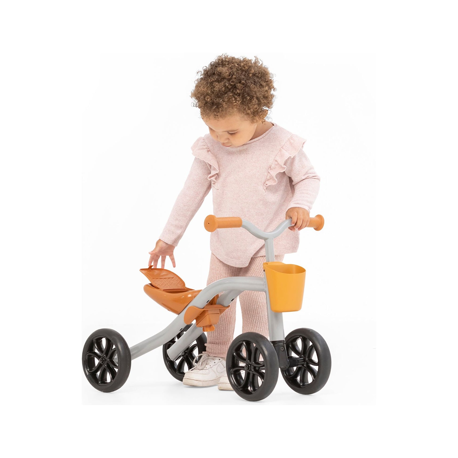 girl with Chillafish Quadie 2 Ride-On and Basket Silver