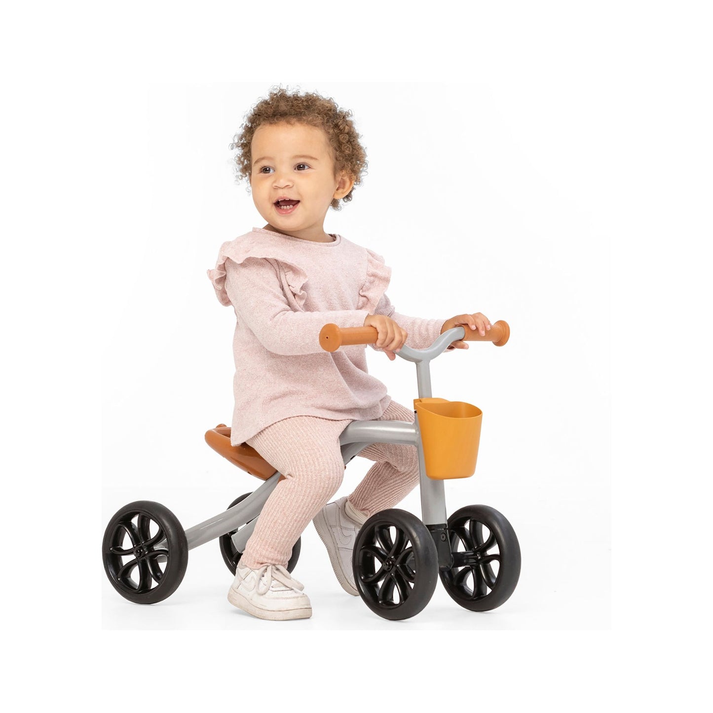 girl sitting on Chillafish Quadie 2 Ride-On and Basket Silver