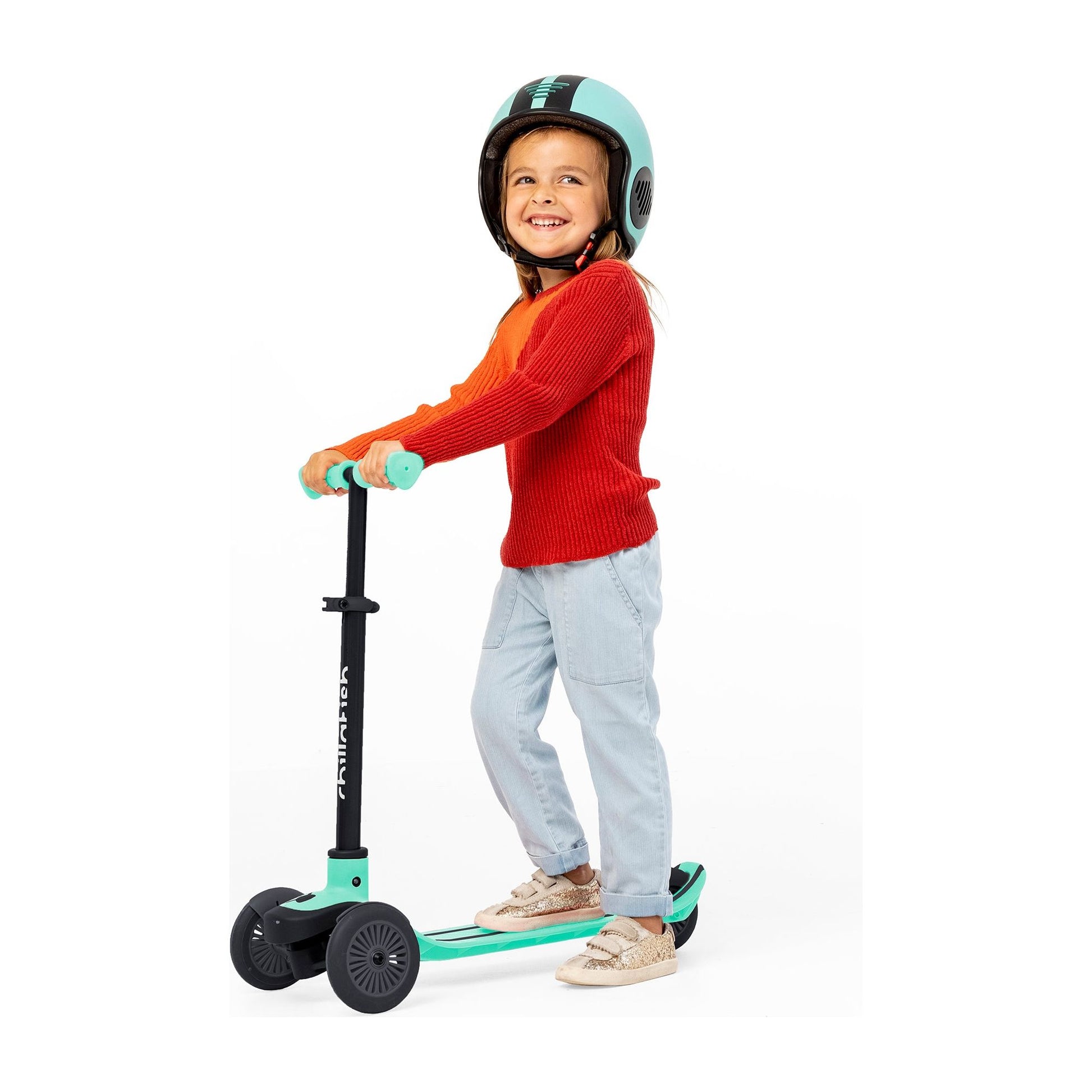 smiling girl standing on Chillafish Scotti Scooter Mint