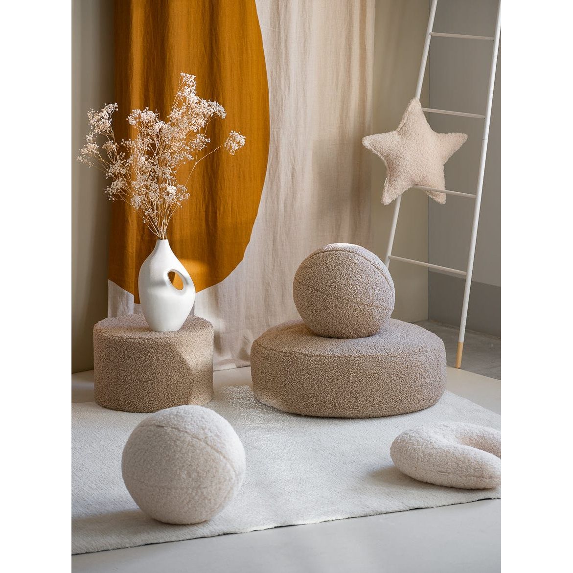 Wigiwama Biscuit Ball Cushion in room with side table and pouffe