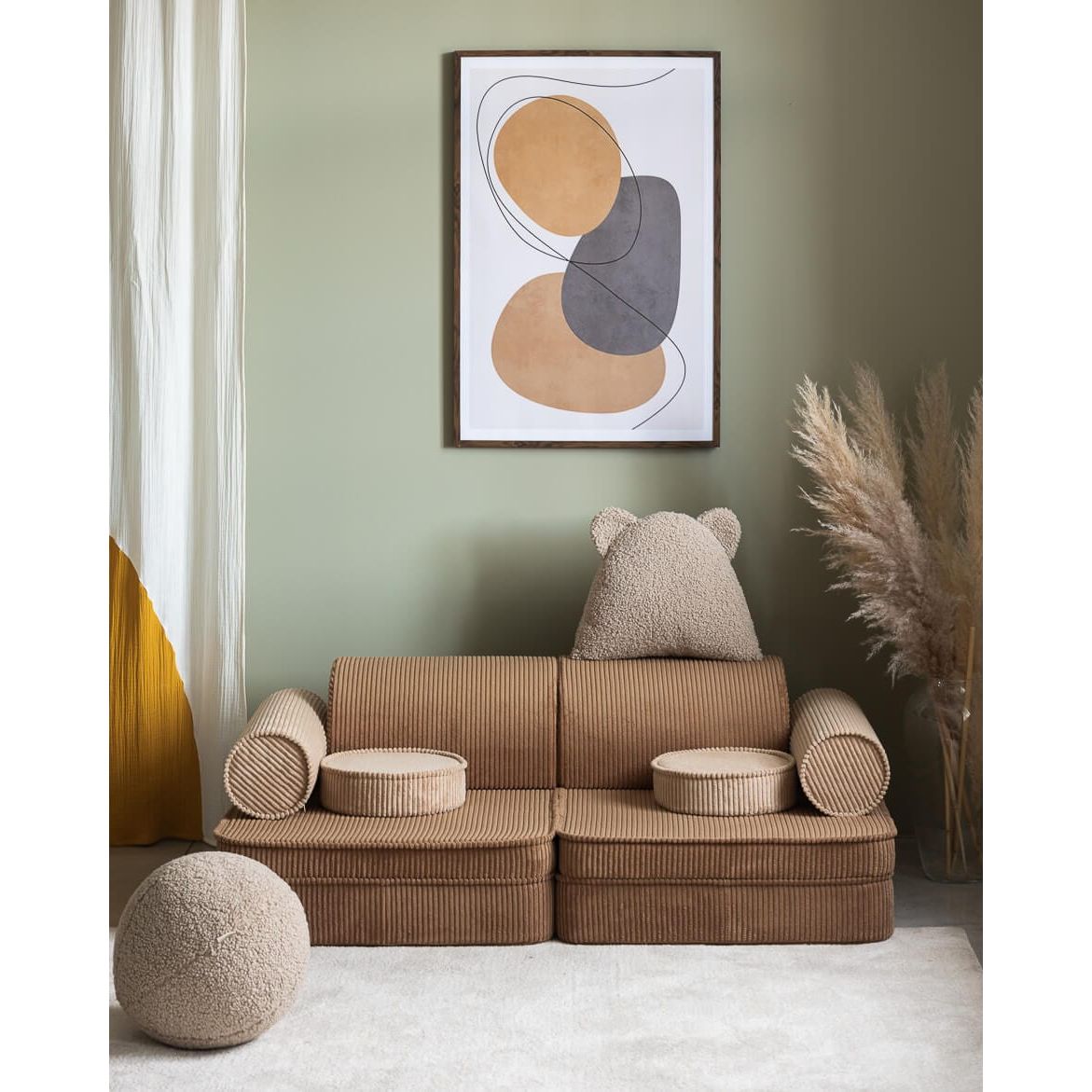 Wigiwama Toffee Settee in front of wall art