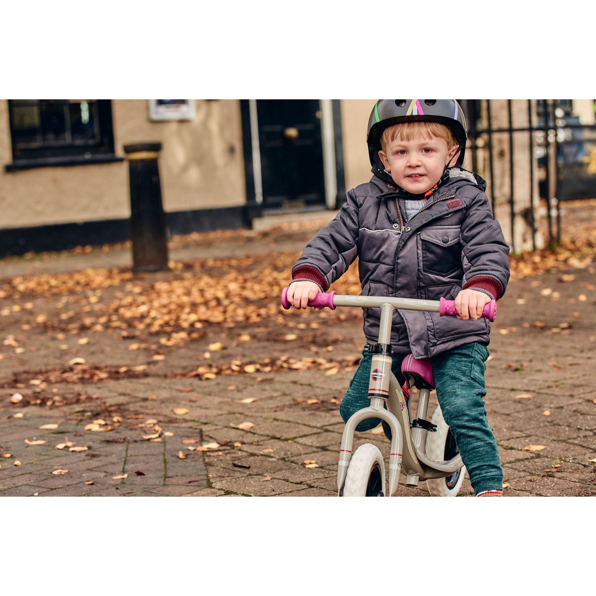 boy riding on Ride-Ezy Go Balance Bike - Pink & Silver on pavement